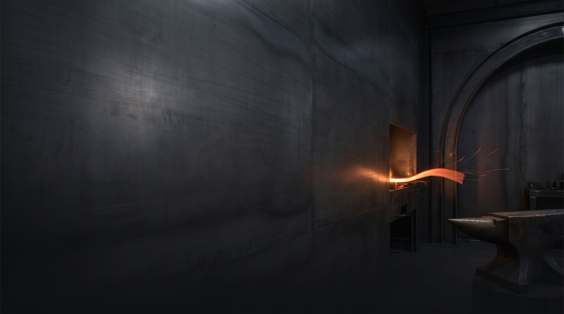 A controlled ribbon of forge heat glowing in a dark workshop